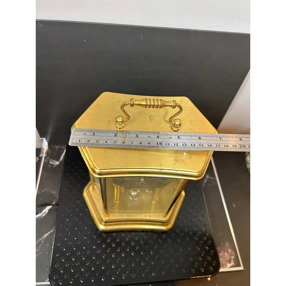 vintage German mantle clock with gold hexagonal glass case and etched roses.
